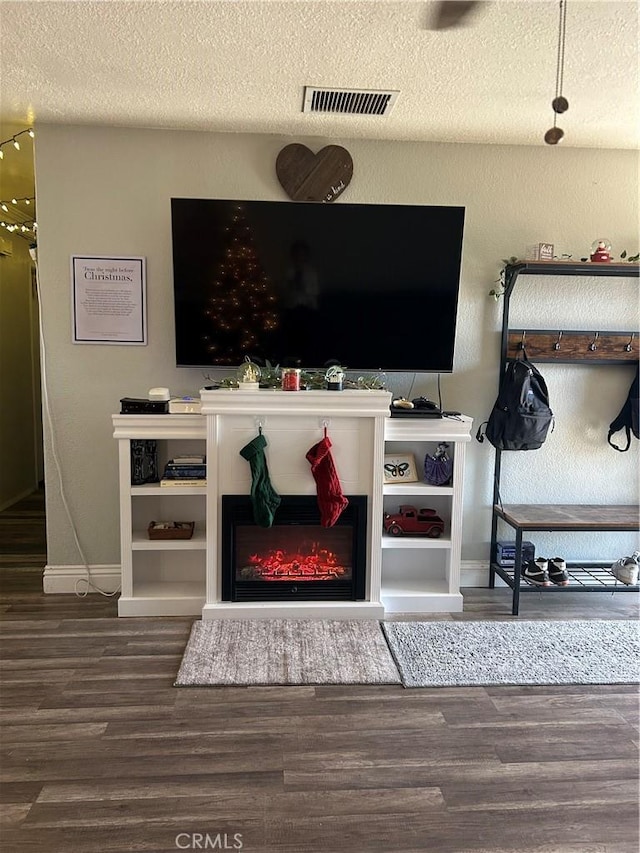 living room with hardwood / wood-style floors and a textured ceiling