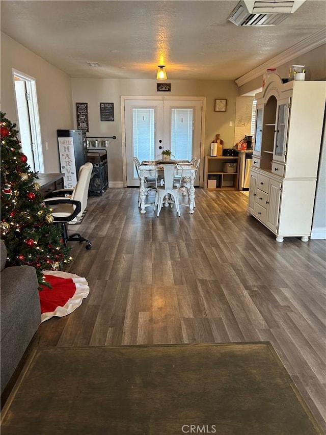 dining area featuring dark hardwood / wood-style flooring and a textured ceiling