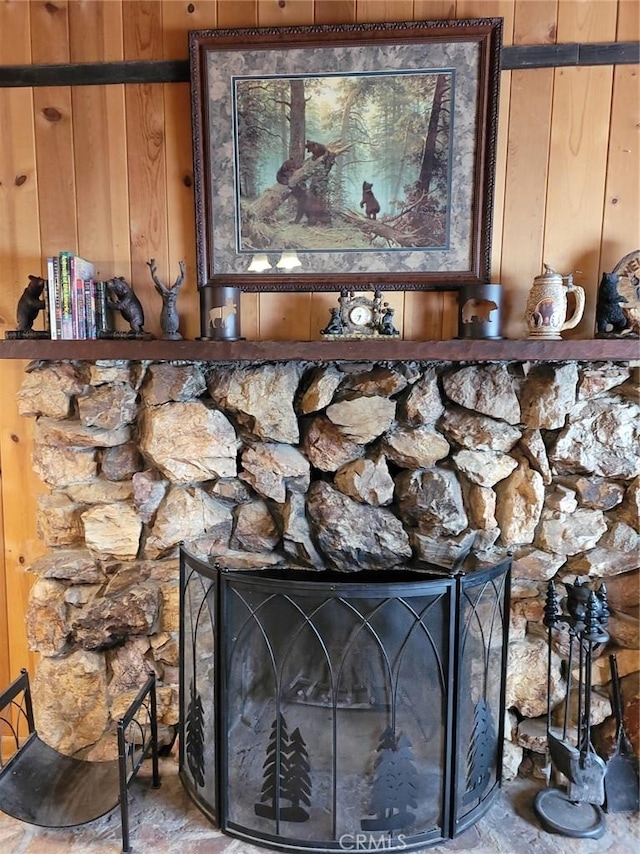 details with wood walls and a fireplace