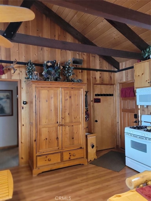 kitchen featuring white gas stove, wooden ceiling, lofted ceiling with beams, wood walls, and wood-type flooring