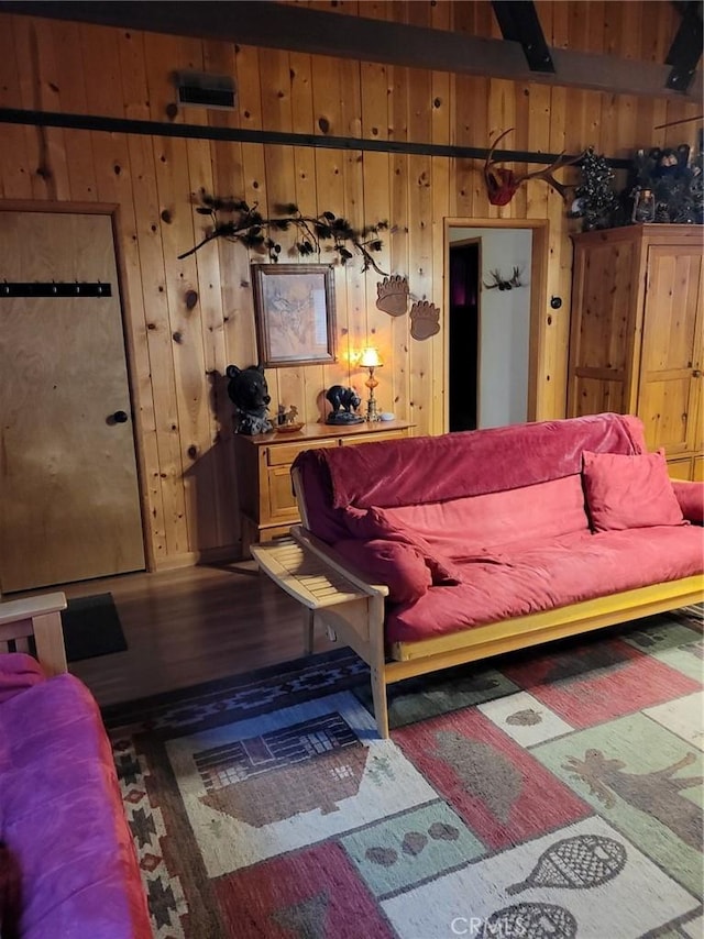 living room featuring hardwood / wood-style floors and wooden walls