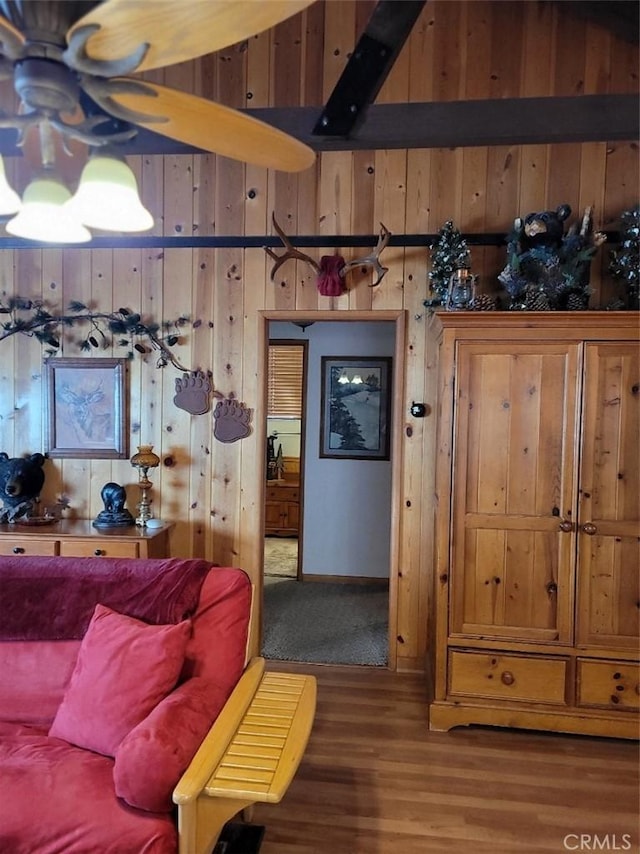 living room with wood walls and hardwood / wood-style flooring