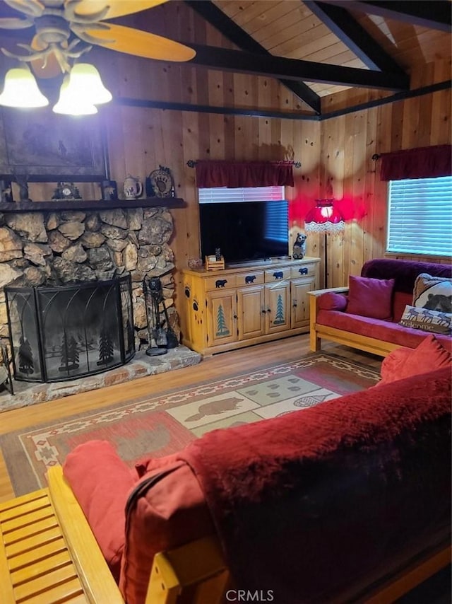 living room with wood ceiling, a fireplace, and lofted ceiling with beams