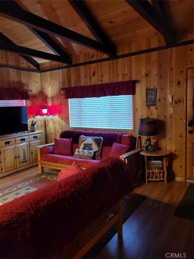 living room featuring vaulted ceiling with beams, hardwood / wood-style flooring, wooden walls, and wood ceiling