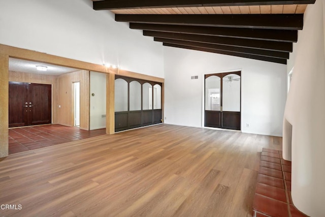 spare room featuring beam ceiling, wood ceiling, wood-type flooring, and high vaulted ceiling