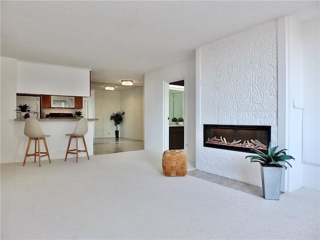 living room with light carpet and a textured ceiling