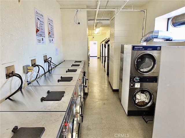 laundry area with stacked washer / drying machine