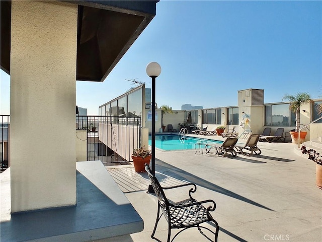 view of swimming pool with a patio area