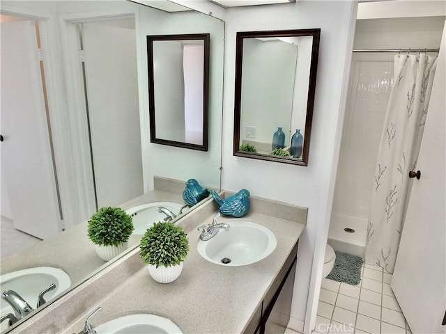 bathroom with toilet, vanity, tile patterned floors, and a shower with shower curtain