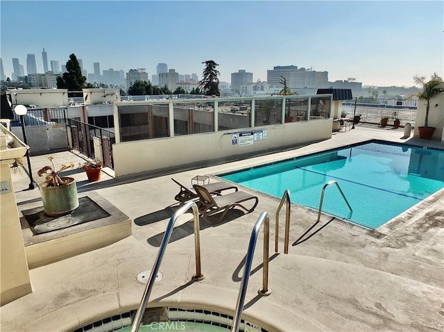 view of pool featuring a community hot tub and a patio