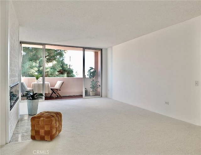 living area featuring light colored carpet and a textured ceiling