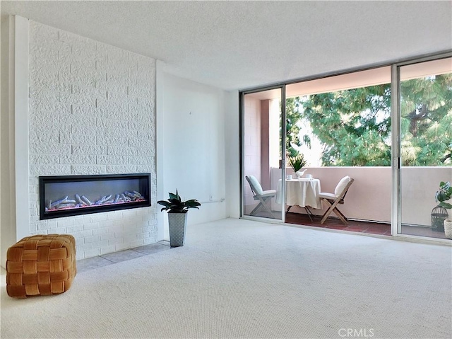 living room with carpet flooring, plenty of natural light, and a textured ceiling