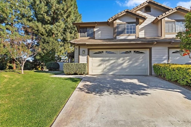 view of front of property with a front lawn and a garage