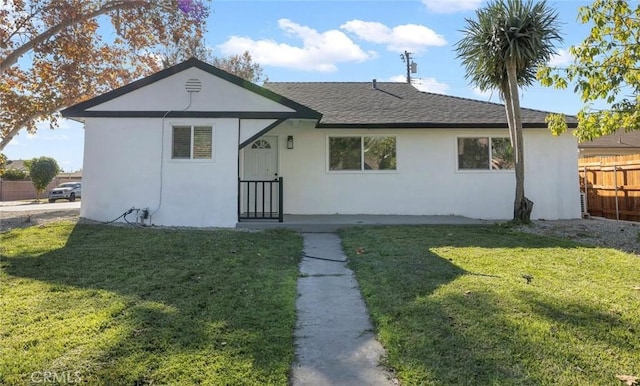 rear view of property with a yard