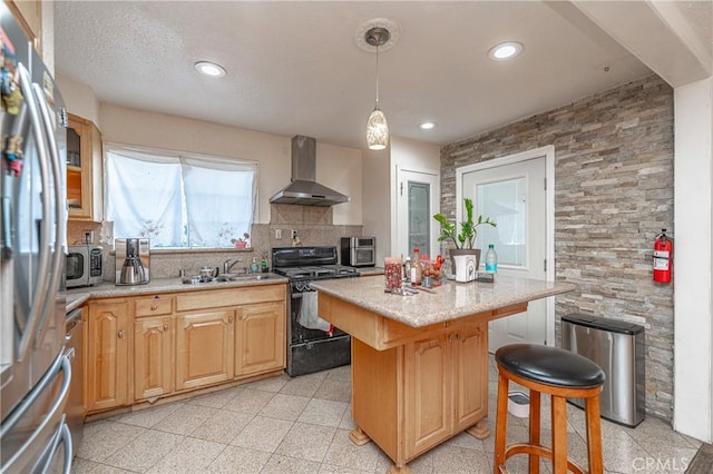 kitchen featuring decorative backsplash, wall chimney exhaust hood, stainless steel appliances, sink, and a kitchen island