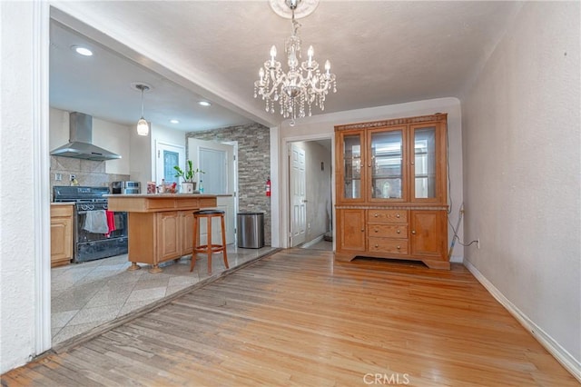 dining area with a notable chandelier and light wood-type flooring