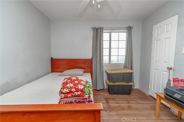 bedroom with hardwood / wood-style flooring and ceiling fan