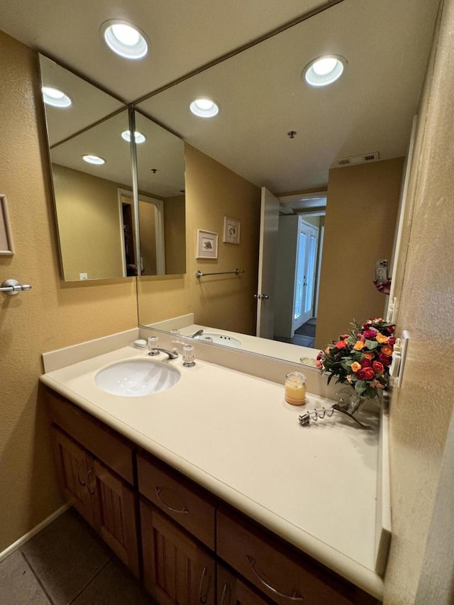 bathroom with tile patterned floors and vanity