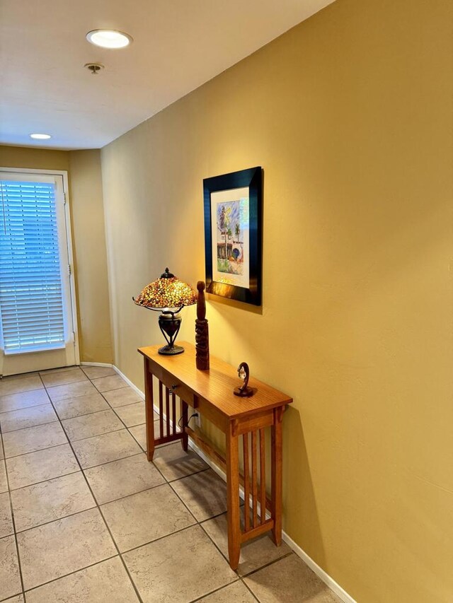 doorway with light tile patterned floors