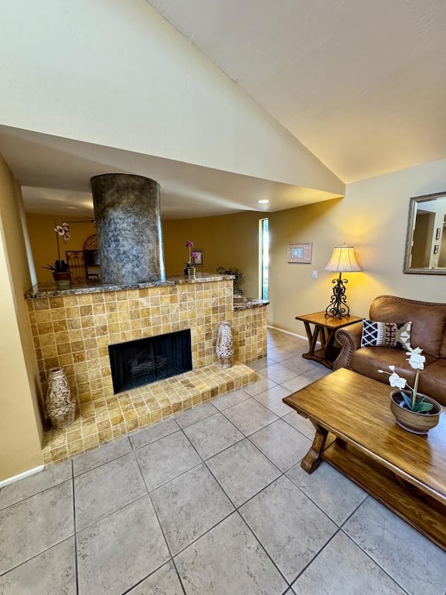 tiled living room featuring a fireplace and vaulted ceiling