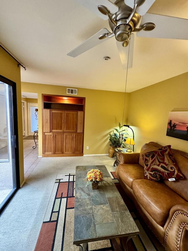 carpeted living room featuring ceiling fan