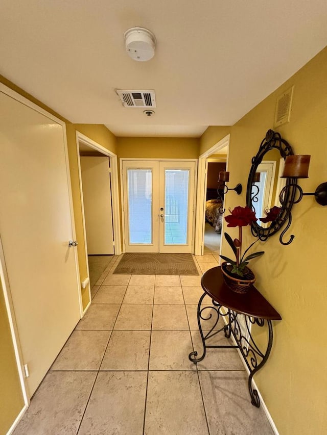 doorway featuring tile patterned floors and french doors