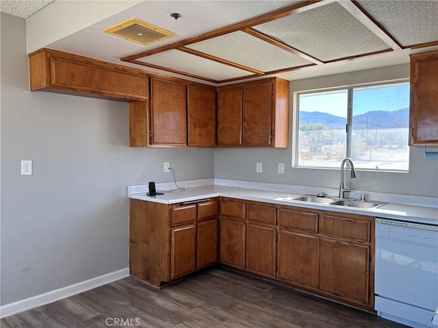 kitchen with dishwasher, a mountain view, sink, and dark hardwood / wood-style flooring