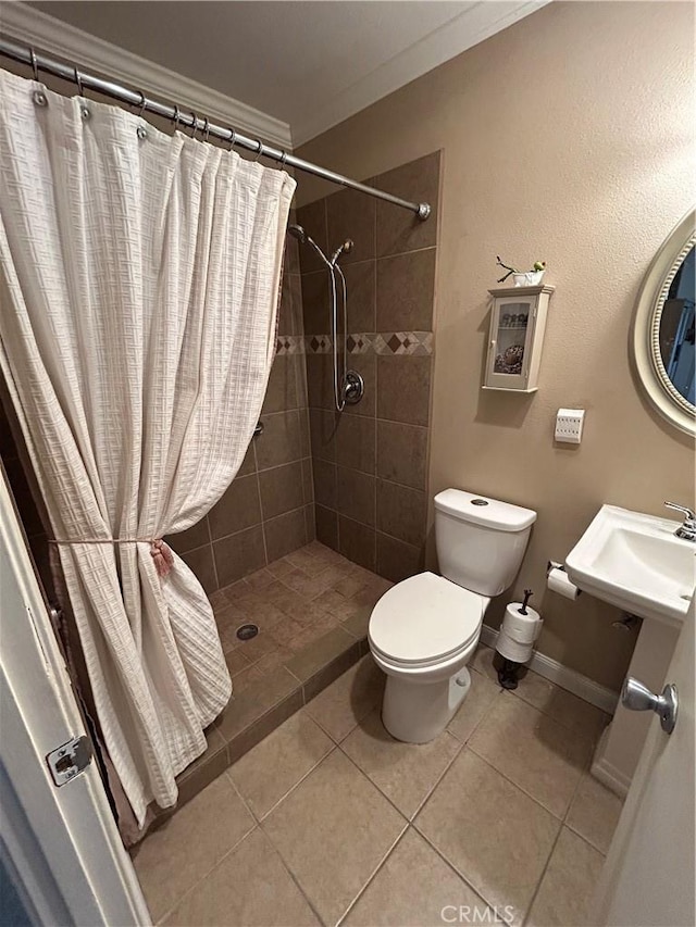 bathroom featuring sink, a shower with curtain, tile patterned floors, and toilet