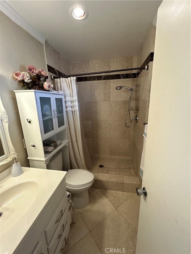 bathroom featuring vanity, curtained shower, tile patterned floors, and toilet