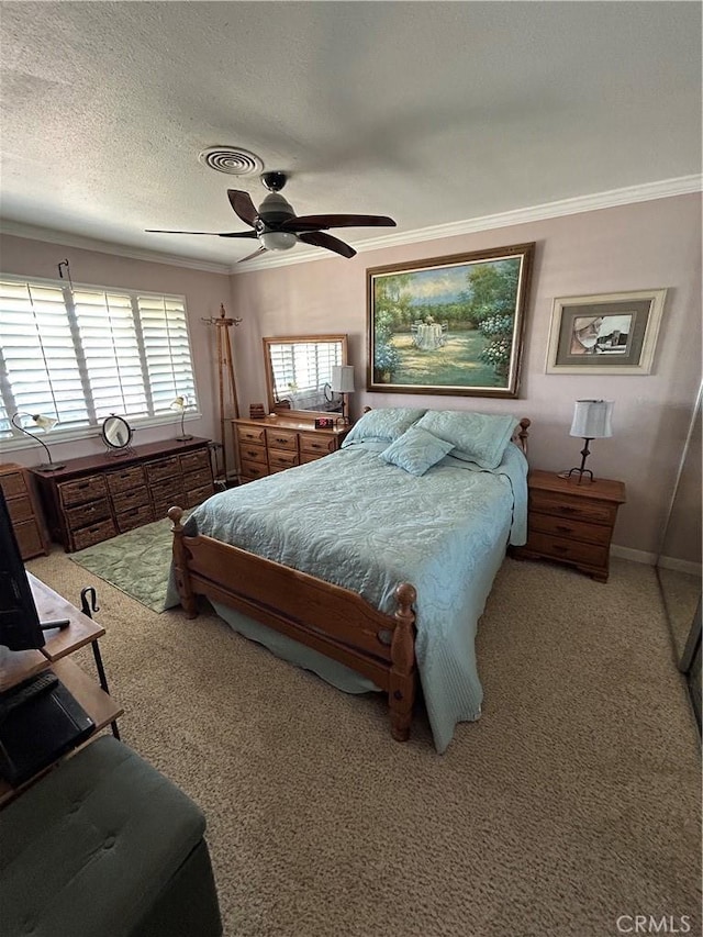 carpeted bedroom featuring ornamental molding, ceiling fan, and a textured ceiling