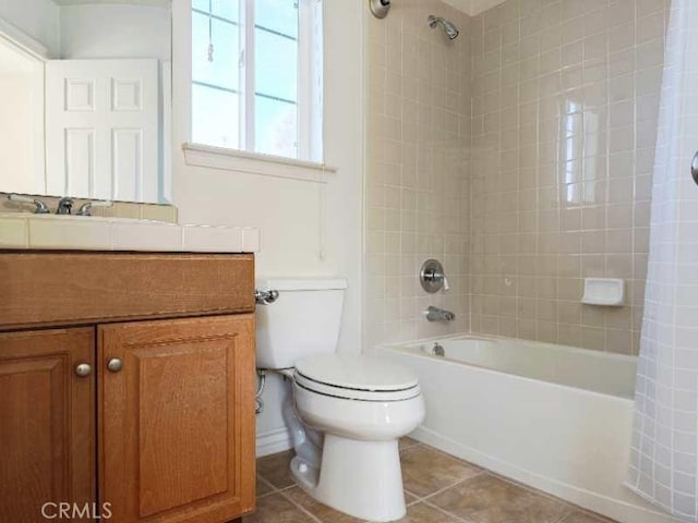 full bathroom with tile patterned flooring, shower / bath combo, toilet, and vanity