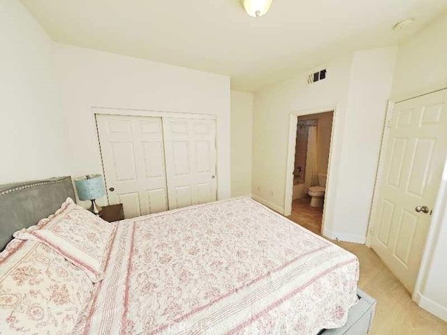 bedroom featuring ensuite bath and a closet