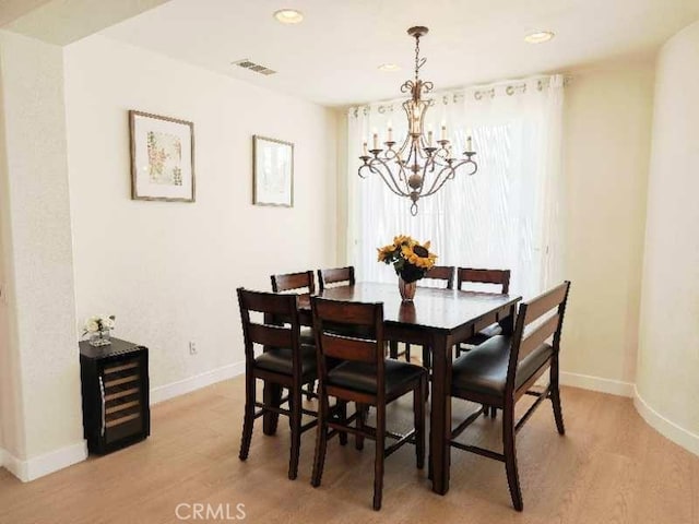 dining room featuring a chandelier and light hardwood / wood-style flooring