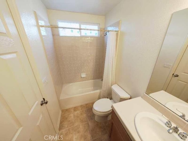 full bathroom featuring tile patterned flooring, shower / bath combo, toilet, and vanity