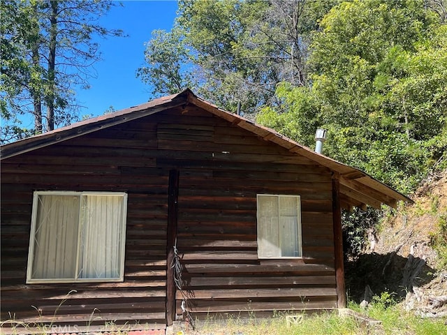 view of side of home featuring an outbuilding