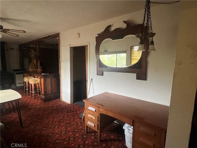 interior space with a ceiling fan and carpet flooring