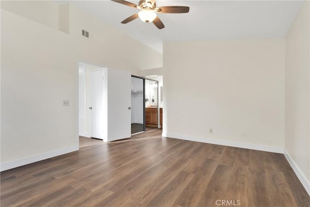 spare room featuring high vaulted ceiling, ceiling fan, and dark wood-type flooring