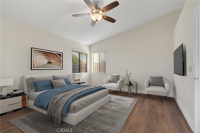 bedroom with lofted ceiling, ceiling fan, and dark wood-type flooring