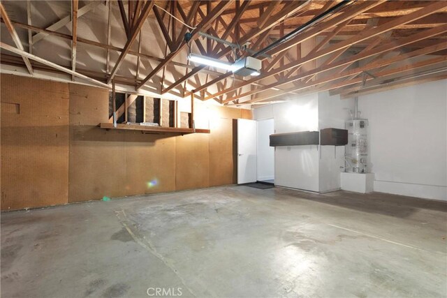 garage with secured water heater and a garage door opener