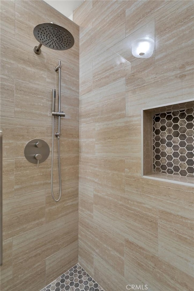 bathroom with tiled shower