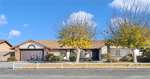 ranch-style house featuring brick siding, a garage, and concrete driveway