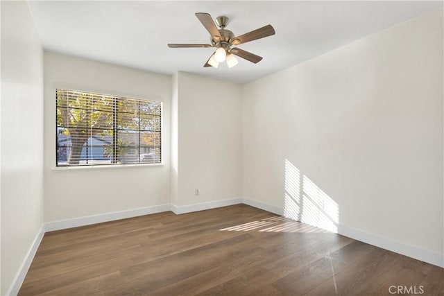 empty room featuring ceiling fan and dark hardwood / wood-style floors