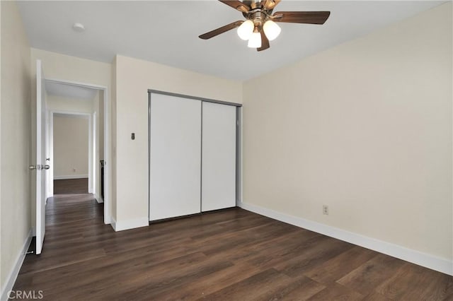 unfurnished bedroom with ceiling fan, a closet, and dark hardwood / wood-style floors