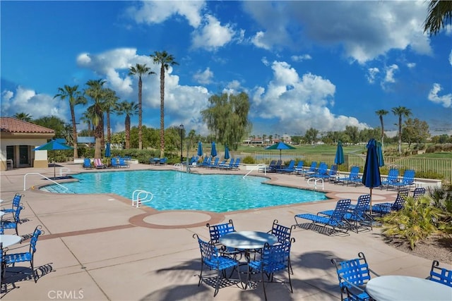 view of swimming pool with a patio