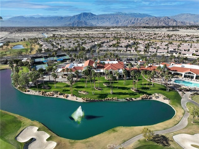 birds eye view of property featuring a water and mountain view