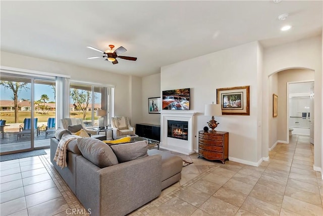 living room featuring ceiling fan and light tile patterned floors