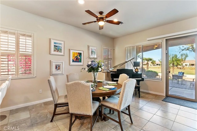 tiled dining area featuring ceiling fan