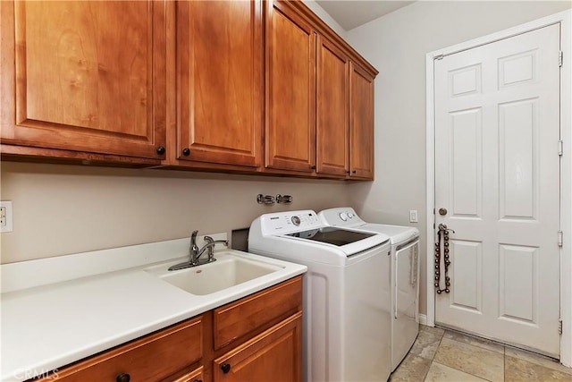 laundry room featuring washer and dryer, cabinets, and sink