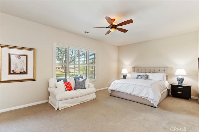 bedroom with ceiling fan and light carpet