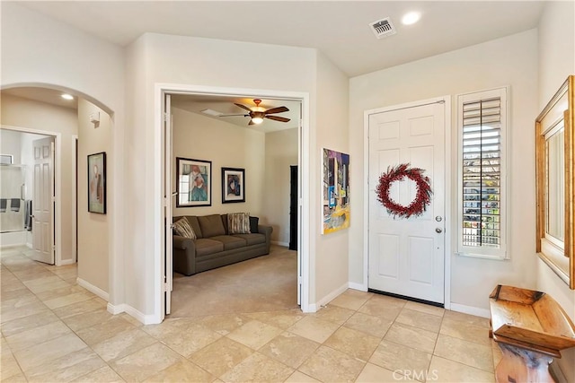 entrance foyer with light carpet and ceiling fan